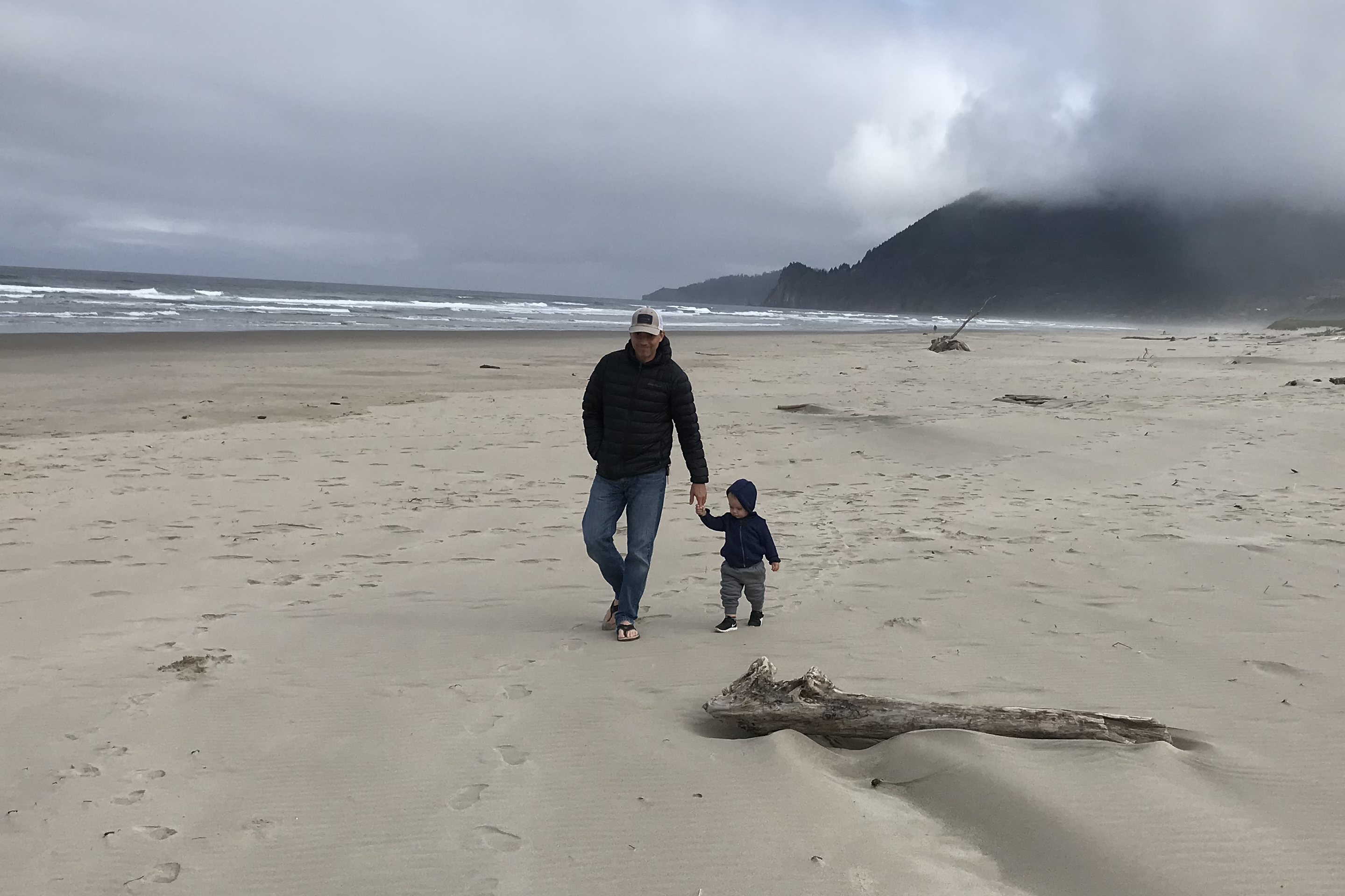 Greg walking on the beach with tiny man